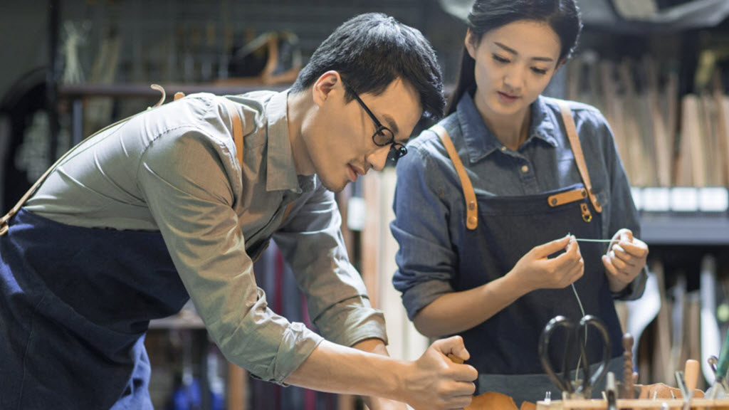 people in a workshop using tools